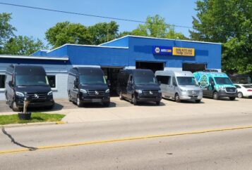 sprinter vans parked outside repair shop